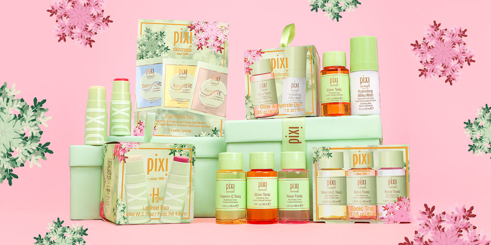 Holiday Gift Sets on a pink background surrounded by snowflakes