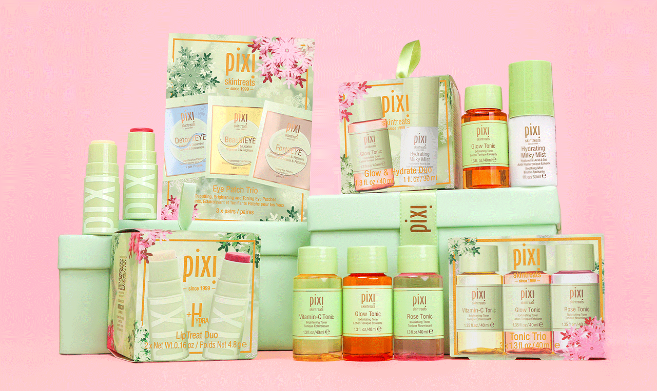 Holiday Gift Sets on a pink background surrounded by snowflakes