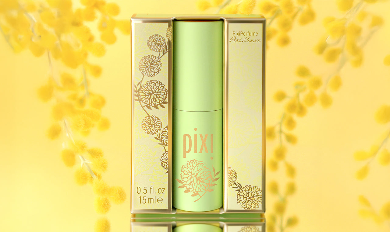 PixiPerfume PixiMimosa on a yellow background with branches