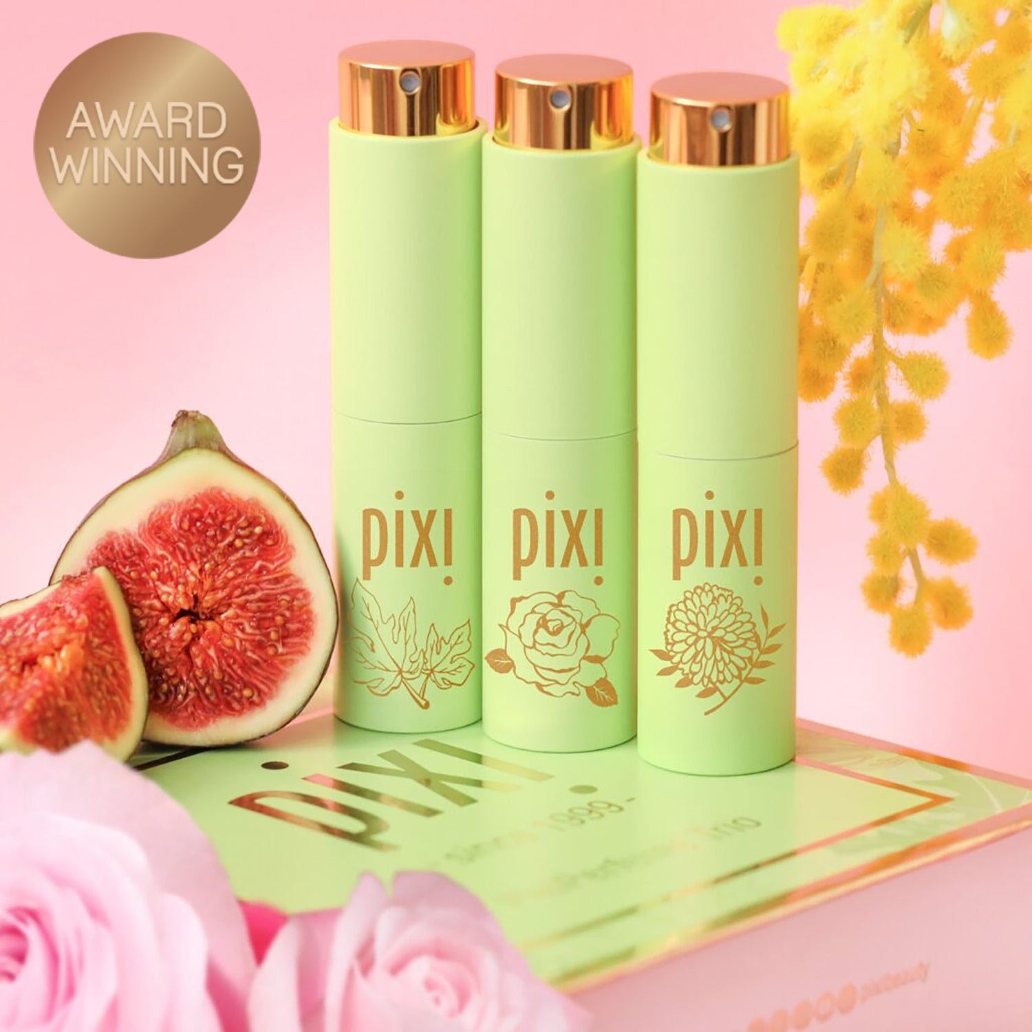 Award Winning: PixiPerfume Gift Trio shown on a pink background with plants - view 2