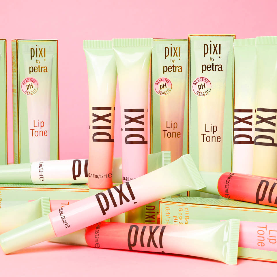 LipTone all shades shown on a pink background alongside box packaging view 1